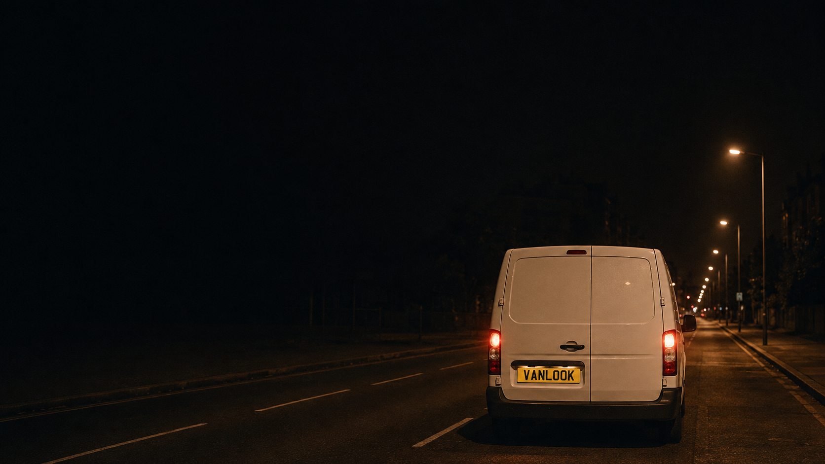 A VanLook van driving away down a lit road at night